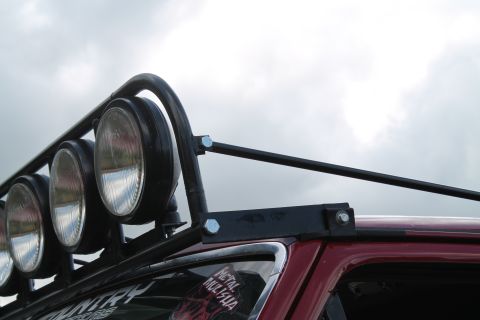1990 Ford Bronco - Roof rack with auxiliary lights attached to the top of a vehicle.