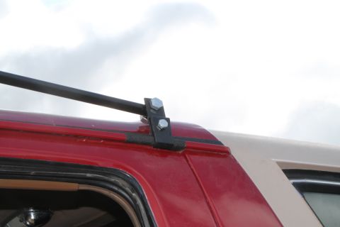 1990 Ford Bronco - A close-up view of a roof rack mount on a two-tone SUV.