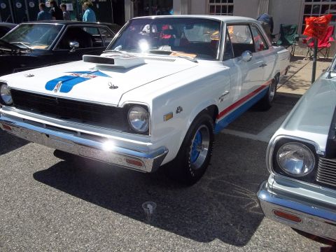 1970 Ford Ranchero - White 1970 AMC Gremlin X parked next to another car, racing stripes.
