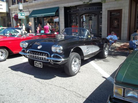 1970 Ford Ranchero - A black 1958 Chevrolet Corvette convertible with a prominent grille and dual carburetors is parked on a street.