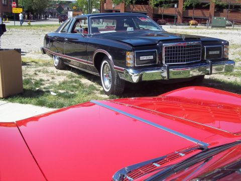 1970 Ford Ranchero - A black 1977-1979 Ford LTD II coupe is parked next to a red car.