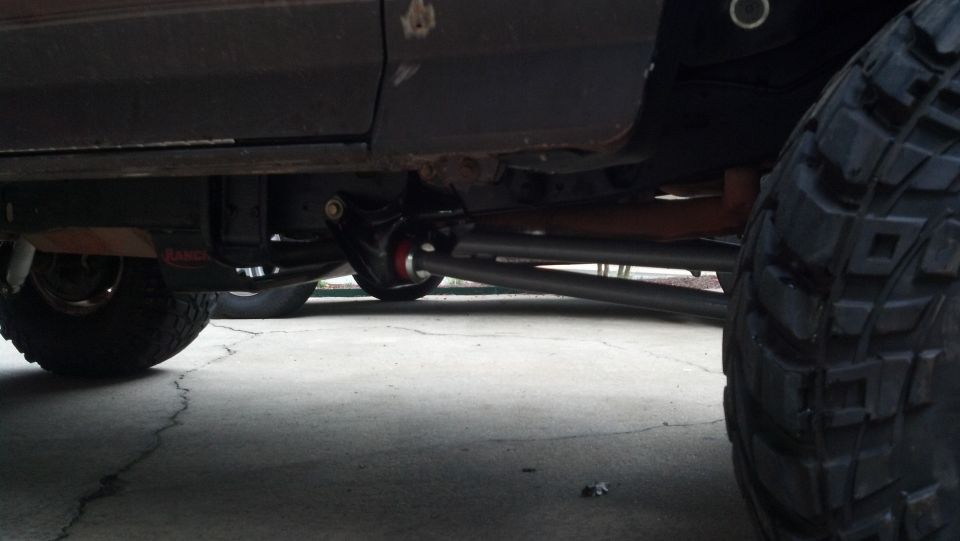 Underbody view of a vehicle showing suspension and large tire