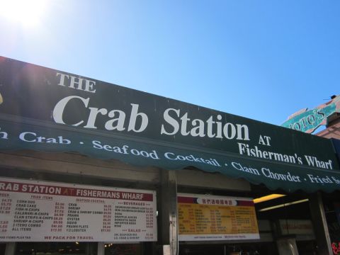 1991 Ford LTD Crown Victoria - A sign for The Crab Station restaurant is visible against a clear blue sky, with menus displayed below.