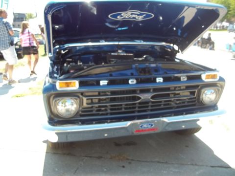 1970 Ford Ranchero - Front view of a blue Ford pickup truck with its hood open, revealing the engine bay.