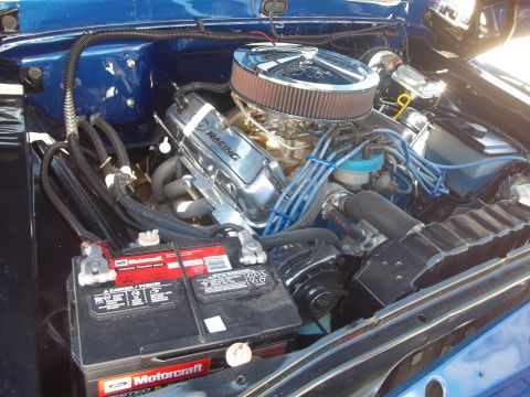 1970 Ford Ranchero - The engine bay of a blue vehicle features chrome valve covers and a prominent air filter.