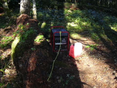 1991 Ford Bronco - Generator and gas can set up in a wooded area, possibly for camping or remote work.
