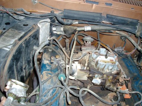 1979 Ford F-150 - Close-up view of the engine bay, showing the carburetor and various hoses and wires.