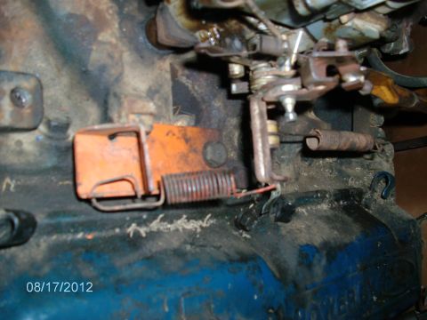 1979 Ford F-150 - Carburetor linkage and springs shown in detail, likely from an engine teardown.
