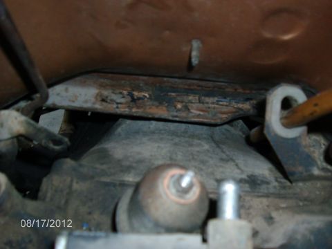 1979 Ford F-150 - A close-up view of the undercarriage of a vehicle, revealing aged metal and mechanical parts.