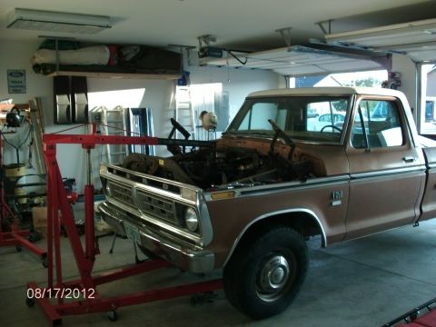1979 Ford F-150 - 1979 Ford F-150 truck undergoing engine removal in a garage.