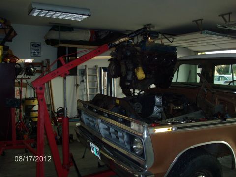 1979 Ford F-150 - Engine removal in progress on a brown truck in a garage.
