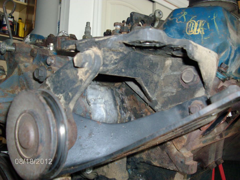 Close-up of engine component with blue valve cover marked 'OK'. Date stamp '08/18/2012' visible