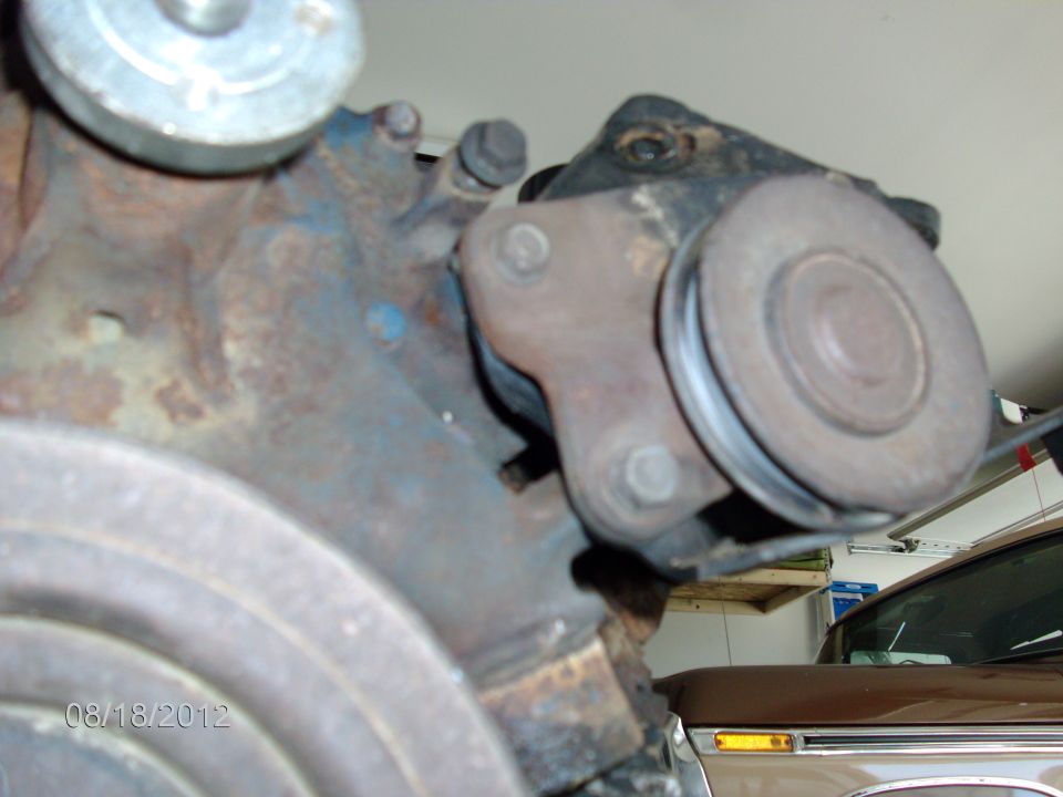 Engine pulley assembly with rust and blue paint flecks, dated 08/18/2012
