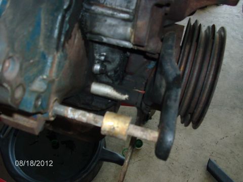1979 Ford F-150 - Engine pulley and block detail, with a drain pan visible underneath.