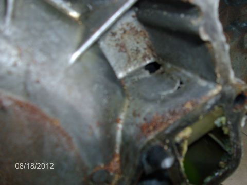 1979 Ford F-150 - A close-up view of a corroded metal component, possibly from an engine, with a date stamp visible.