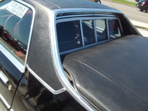 1970 Ford Ranchero - A black 1970 Ford Ranchero is seen from the side, with a 'For Sale' sign on the rear window.