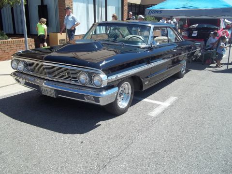 1970 Ford Ranchero - This black 1964 Ford Galaxie features a large hood scoop and custom wheels.