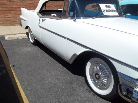 1970 Ford Ranchero - A white convertible is seen from the side, with a sign on the windshield indicating it is a 1956 El Morocco.