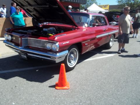 1970 Ford Ranchero - A classic red Pontiac Bonneville is displayed with its hood up, showing the engine compartment.