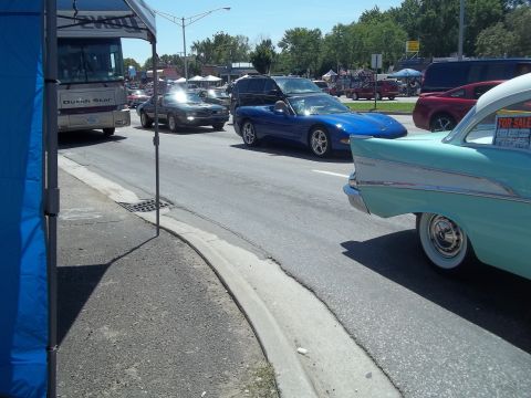 1970 Ford Ranchero - A classic 1957 Chevrolet Bel Air is parked on the street, with other vehicles visible.