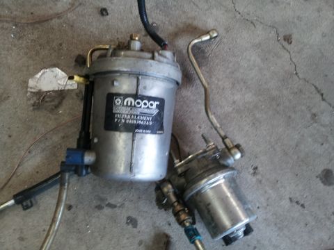1978 Ford Bronco - This image shows a Mopar fuel filter element and pump assembly, with the part number clearly visible on the filter housing.