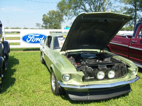 2007 Ford Mustang - A light green 1967 Ford Mustang is displayed with its hood open at an outdoor event.