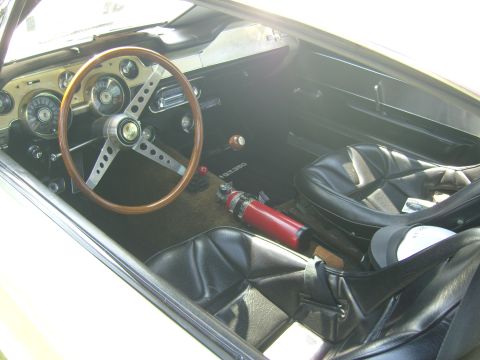 2007 Ford Mustang - Interior of a 1967 Shelby GT350 features a wood steering wheel and racing seats.