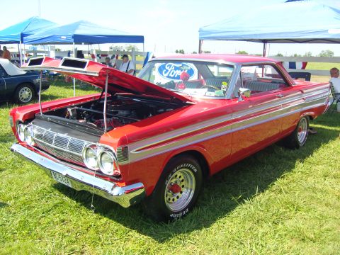 2007 Ford Mustang - A red 1965 Ford Falcon is displayed with its hood open at an outdoor event.