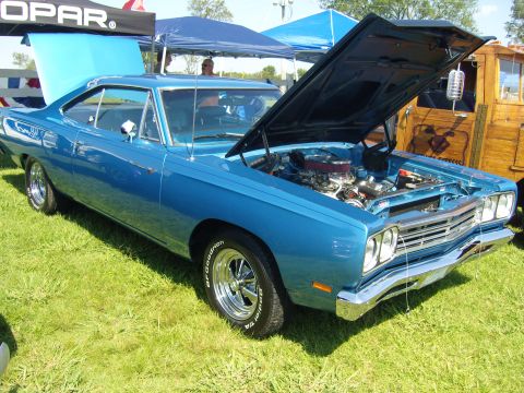 2007 Ford Mustang - A bright blue 1969 Plymouth Road Runner is displayed with its hood open, revealing the engine bay.
