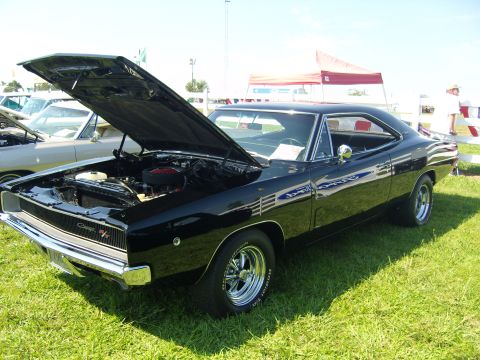 2007 Ford Mustang - A black 1968 Dodge Charger R/T is displayed with its hood open at an outdoor event.