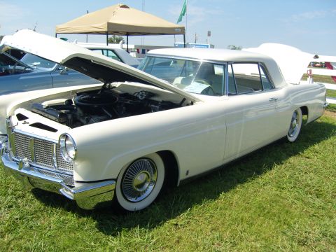 2007 Ford Mustang - A white 1958 Continental convertible is displayed with its hood open at an outdoor event.