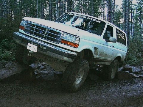 1991 Ford Bronco - This 1991 Ford Bronco navigates a challenging off-road course with large tires and a lifted suspension.