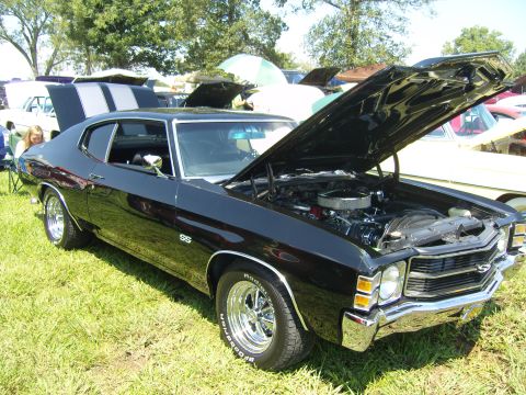 2007 Ford Mustang - A black 1970 Chevrolet Chevelle SS coupe is displayed with its hood open at a car show.