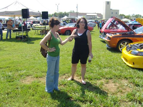 2007 Ford Mustang - People gather at an outdoor event with cars on display.