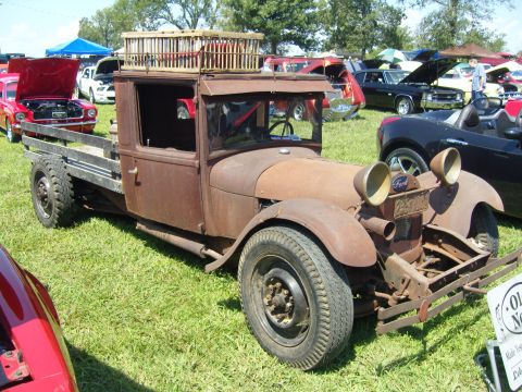 2007 Ford Mustang - This old flatbed truck has a unique wooden cage structure mounted on its roof.