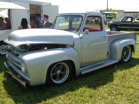 2007 Ford Mustang - A customized 1956 Ford F-series pickup truck is displayed outdoors, with a second pickup truck in the background.
