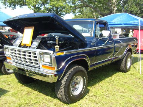2007 Ford Mustang - This blue 1977 Ford F-Series pickup truck is displayed with its hood open at an outdoor event.