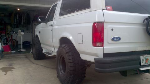 1995 Ford Bronco - This 1995 Ford Bronco is equipped with large off-road tires and parked inside a garage.