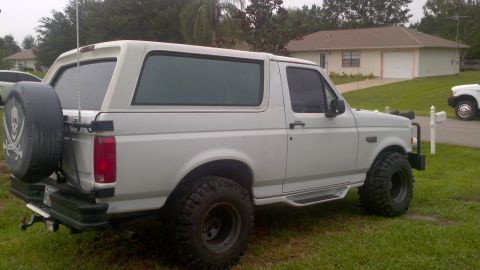 1995 Ford Bronco - This SUV has a spare tire mounted on the rear, with a pirate flag design on its cover.