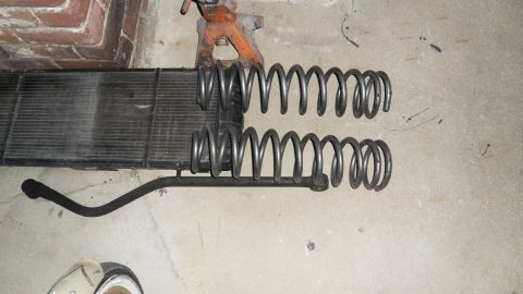 1993 Jeep Cherokee - Coil springs and a radiator are shown laid out on a concrete floor.