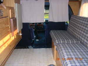 1983 Ford Bronco - Interior view of a van, a bench seat and curtains. Super Motors watermark is visible.