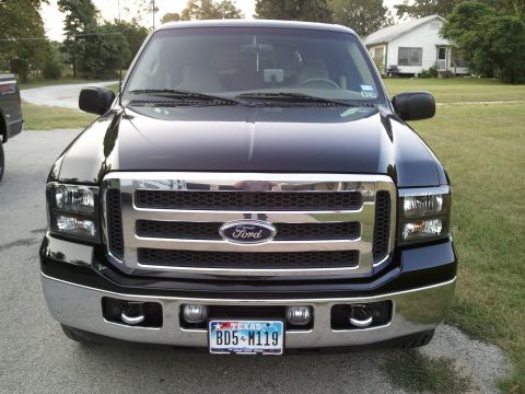 2001 Ford Excursion - Front view of a black Ford Excursion parked outdoors, showing its grille and headlights.