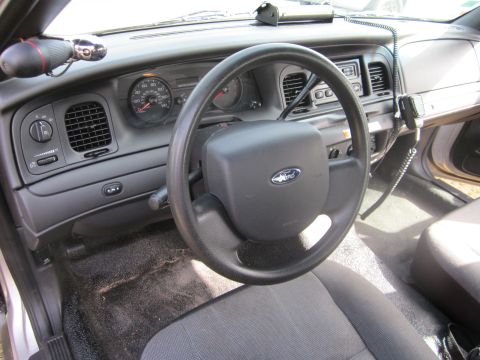1991 Ford LTD Crown Victoria - The interior of a Ford Crown Victoria shows a police radio and other equipment, suggesting it may have been a patrol car.