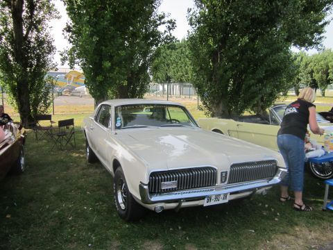 1991 Ford LTD Crown Victoria - A classic Mercury Cougar is displayed outdoors, with another vehicle visible in the background.