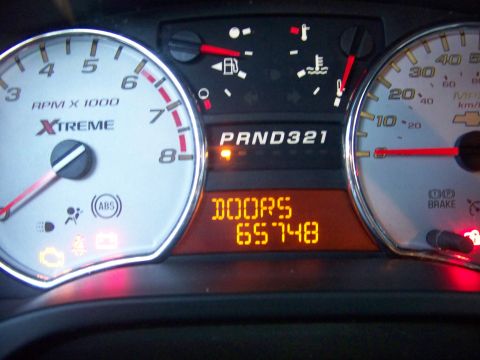 2005 Chevrolet Colorado - Interior view of a vehicle's dashboard gauges with various warning lights illuminated.