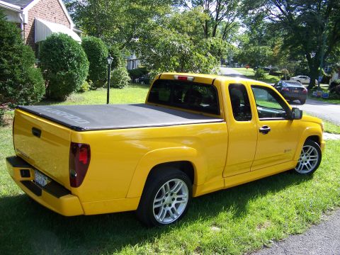 2005 Chevrolet Colorado - This yellow Chevrolet Colorado pickup truck is parked on a grassy lawn in front of a house.