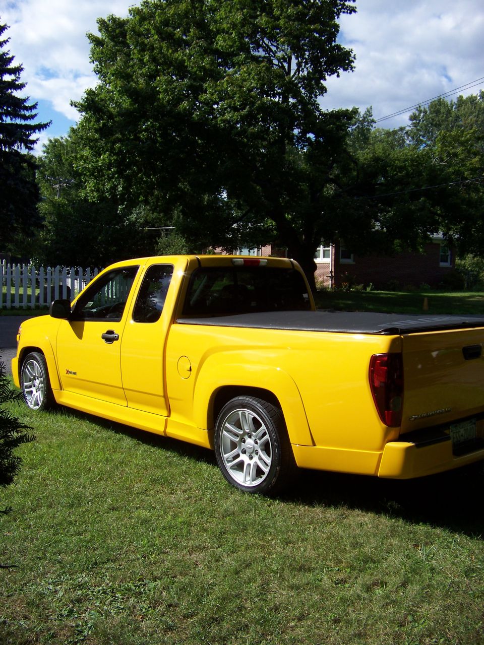 Yellow 2005 Chevrolet Colorado Xtreme pickup truck parked on grass