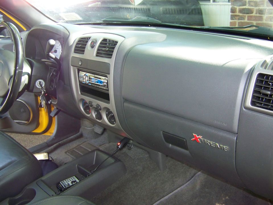 Yellow Chevrolet Colorado interior dashboard with Xtreme badging on glove box