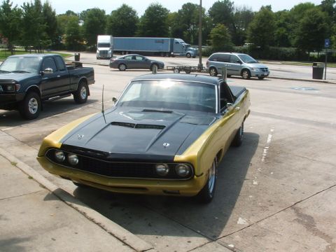 1972 Ford Ranchero - This two-tone pickup truck features a prominent hood scoop and appears to be from the early 1970s.