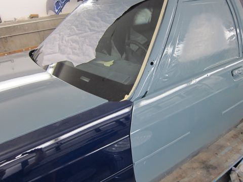 1991 Ford LTD Crown Victoria - A Ford Crown Victoria is being worked on in a garage, showing its front quarter panel and door.